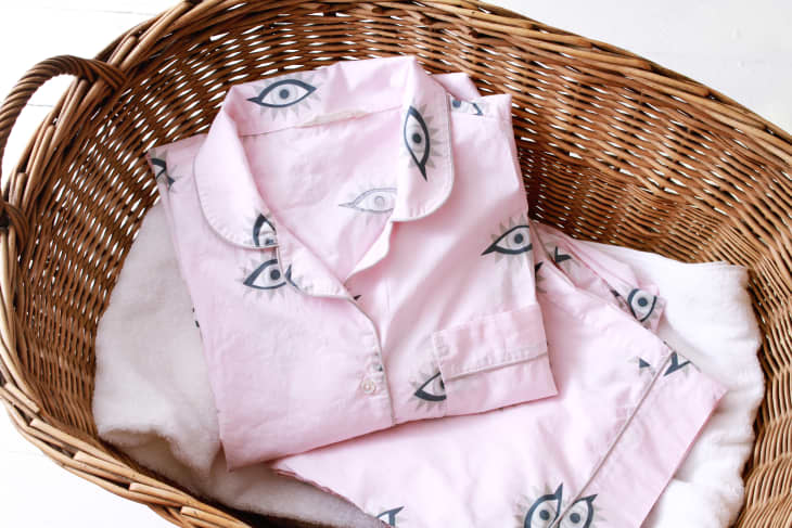 Pink patterned pajamas in a wicker laundry basket