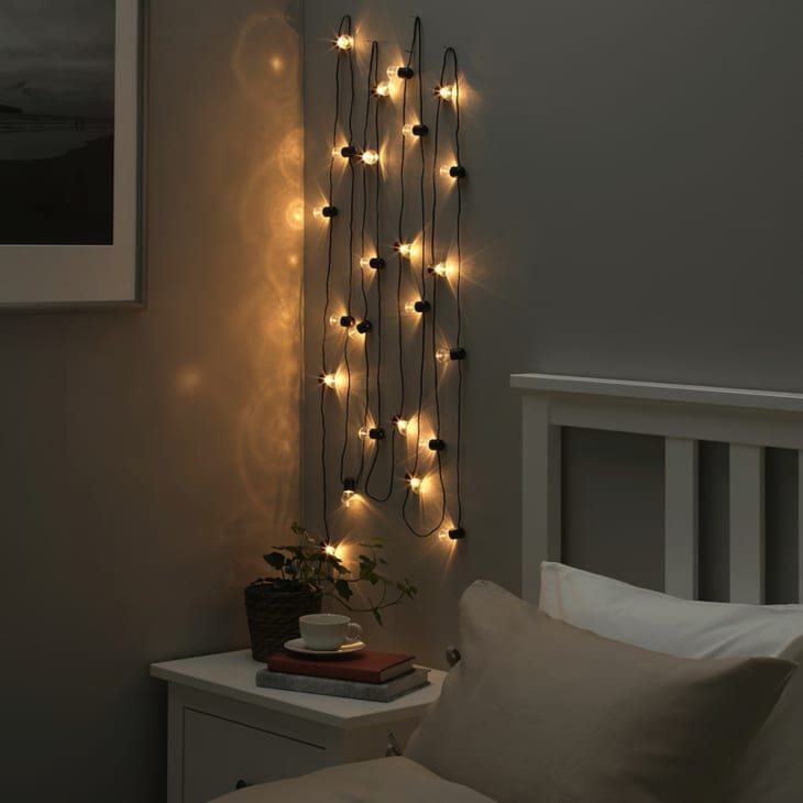 Product photo of IKEA BLÖTSNÖ LED string light with 24 lights, indoor black