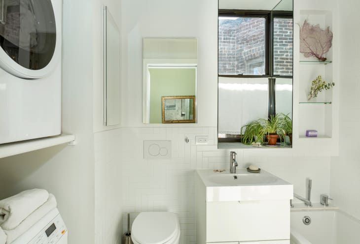 White bathroom in Brooklyn apartment.