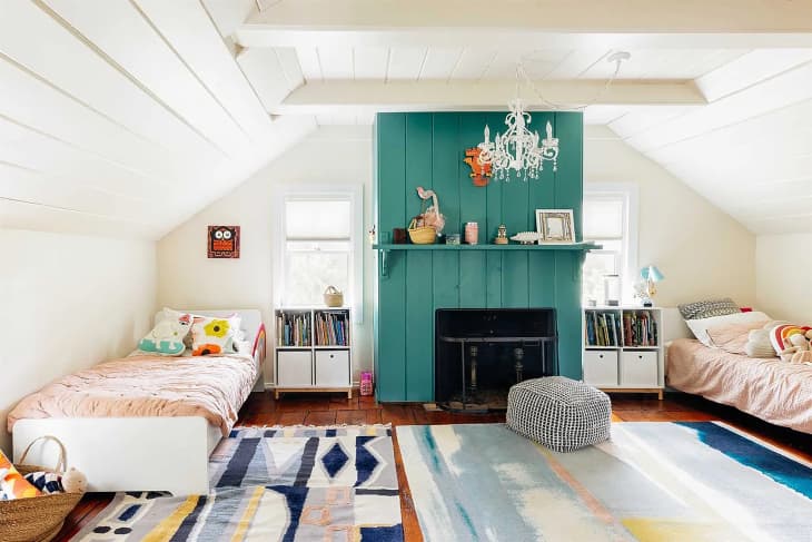 Colorful kids bedroom with white painted wood beam ceilings in historic home.