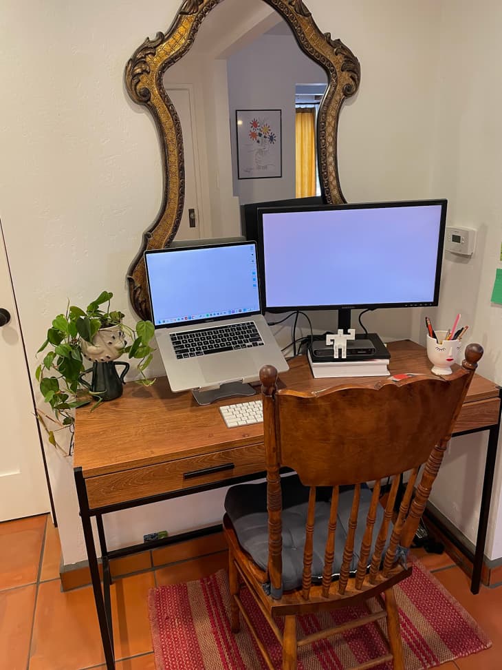 Home office with vintage mirror above desk and monitors.