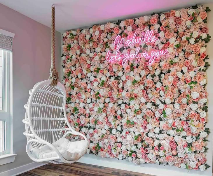 Floral wall with neon sign in bachelorette party house.