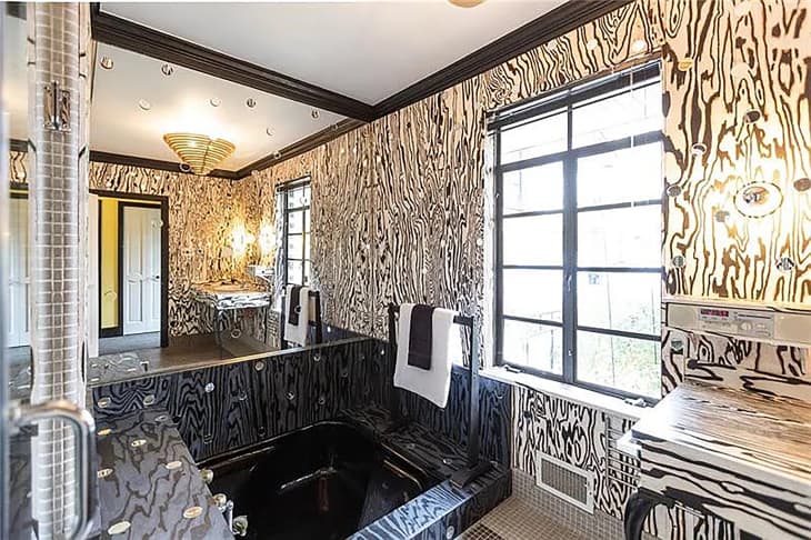 Black and white graphic bathroom in a mirror home.