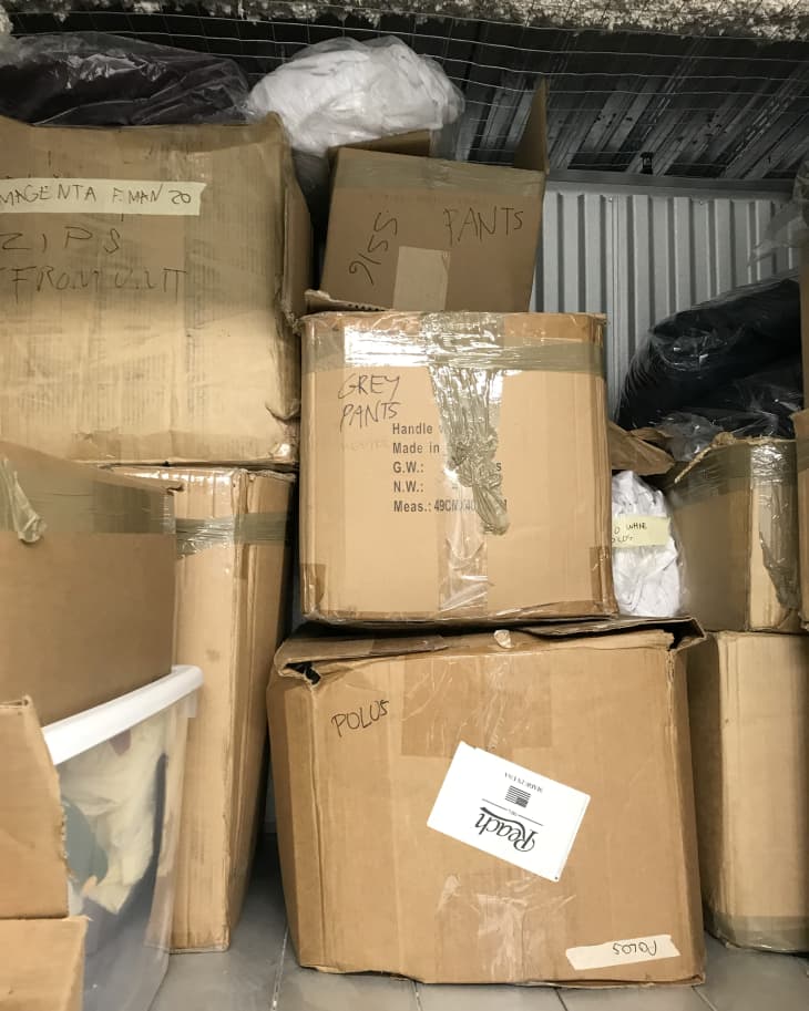 stacks of labeled cardboard boxes in storage unit