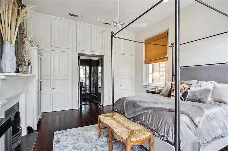 Bright opened bedroom with wrought iron canopy bed.