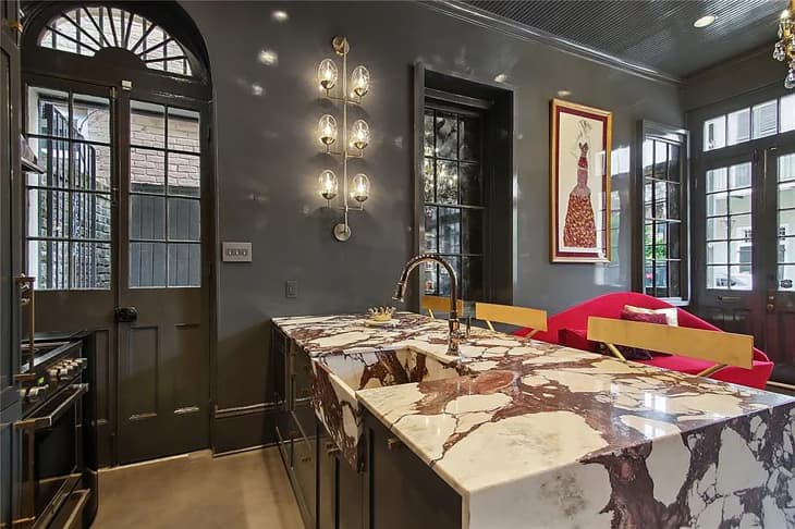 Marble countertops in black painted kitchen.