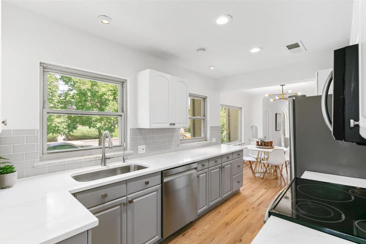 white kitchen with gray cabinets and wood floor