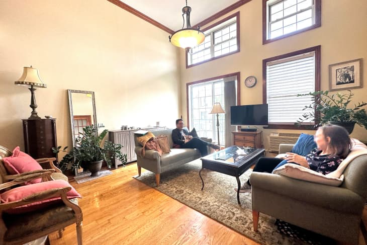 Couple sitting in living room before remodel.