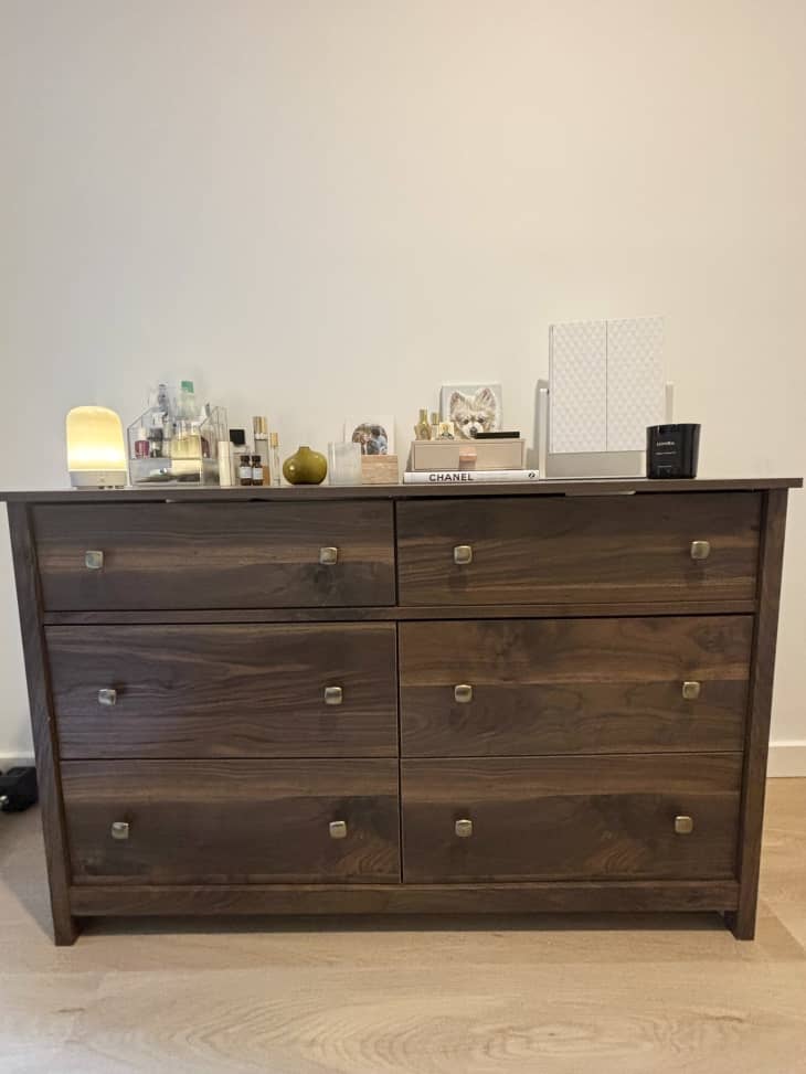 Dresser in a bedroom with items on top.