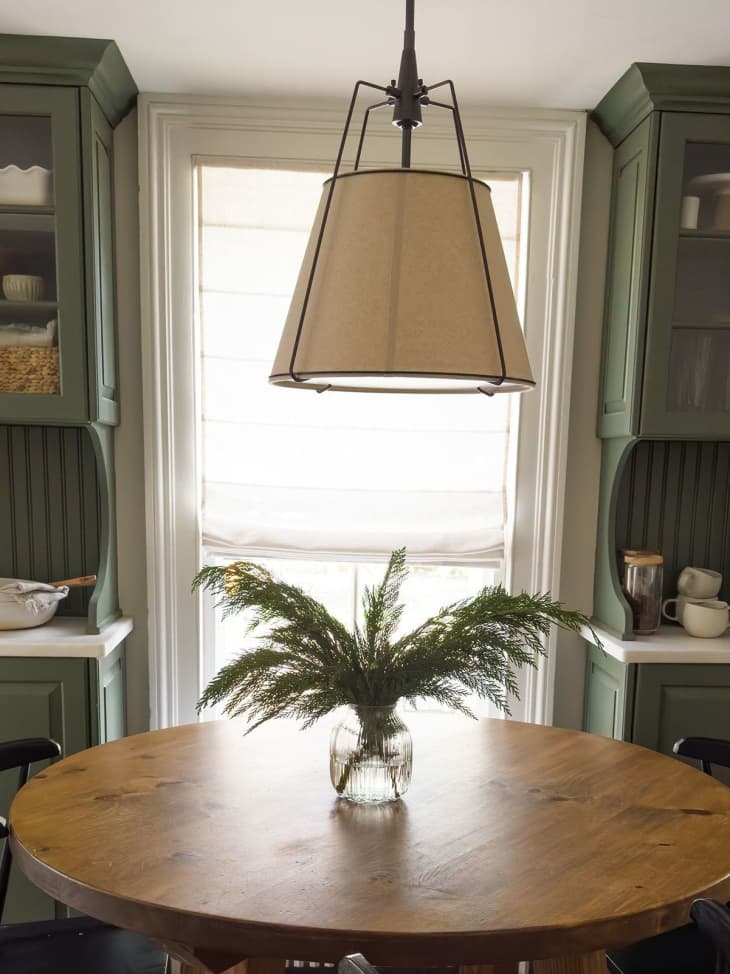 Evergreen arrangement in center of dining room table.