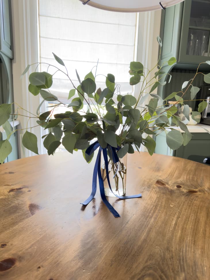 Eucalyptus arrangement on dining room table.