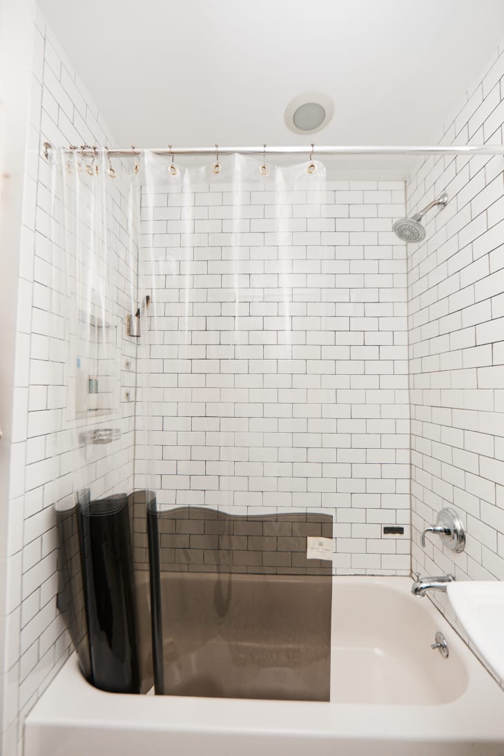Clear shower curtain in a classic white bathroom