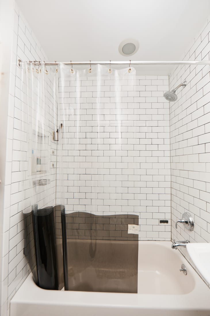 bathtub with shower curtain