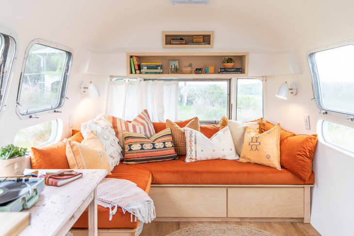Rust-colored sofa in an Airstream makeover