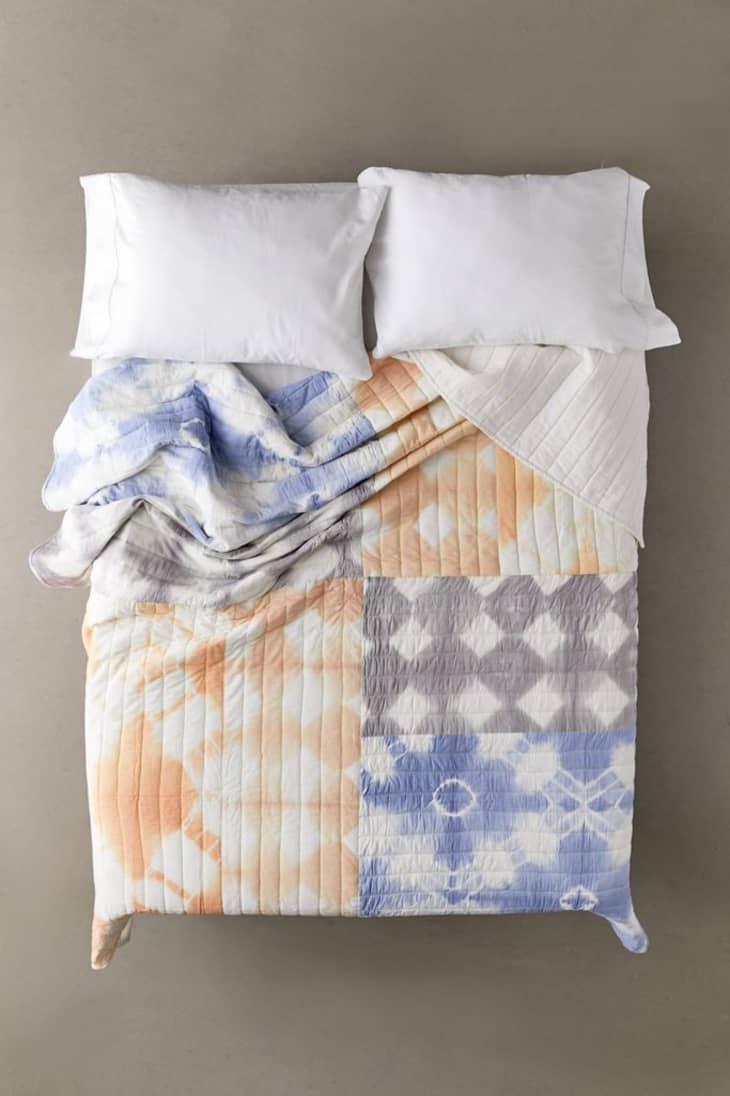 Tie-dye quilt from Urban Outfitters in white, blue, orange, and gray washed out colors