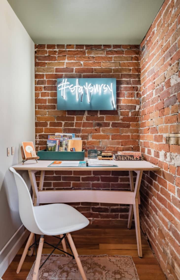 Desk tucked into the entry way in a home designed by The Sursy