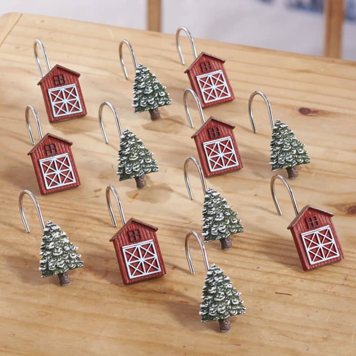 Festive shower hooks with red barns and Christmas trees on them