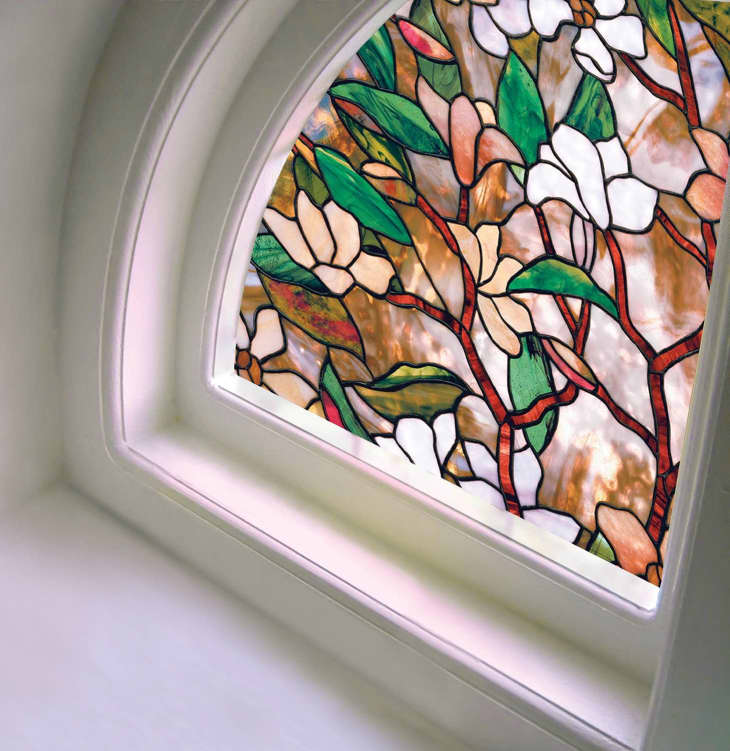 Rounded window with floral stained glass film covering