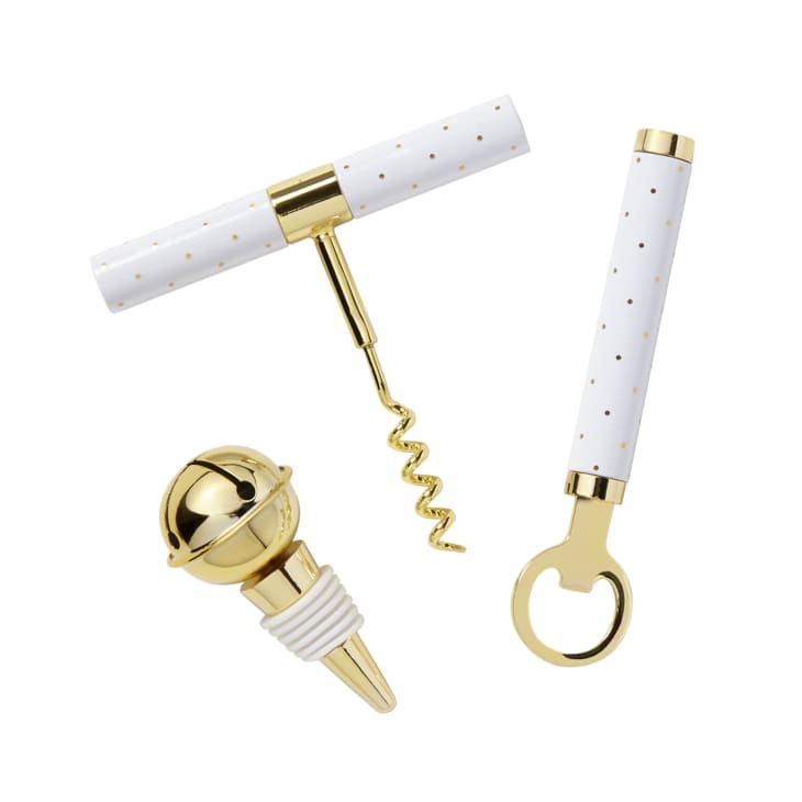 white and gold barware set with a stopper, corkscrew, and bottle opener