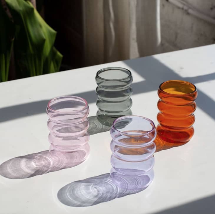Wavy rippled glasses in pink, clear, orange, and gray by Sohpie Lou Jacobsen