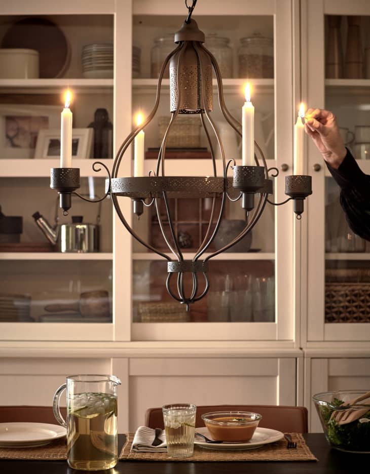 Black steel four-arm chandelier above dining table