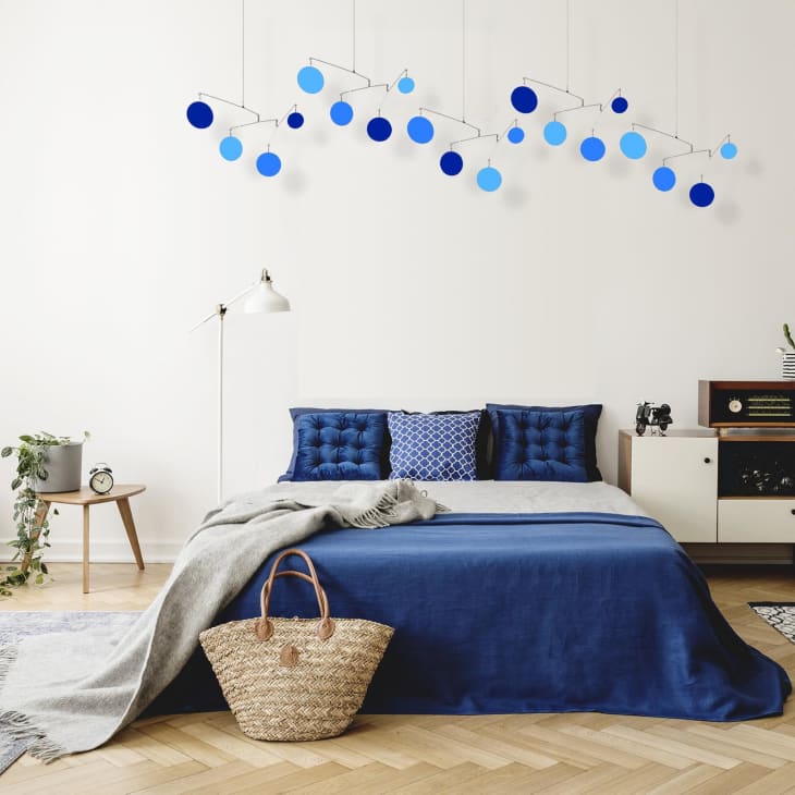 Mobile with blue circles above bed