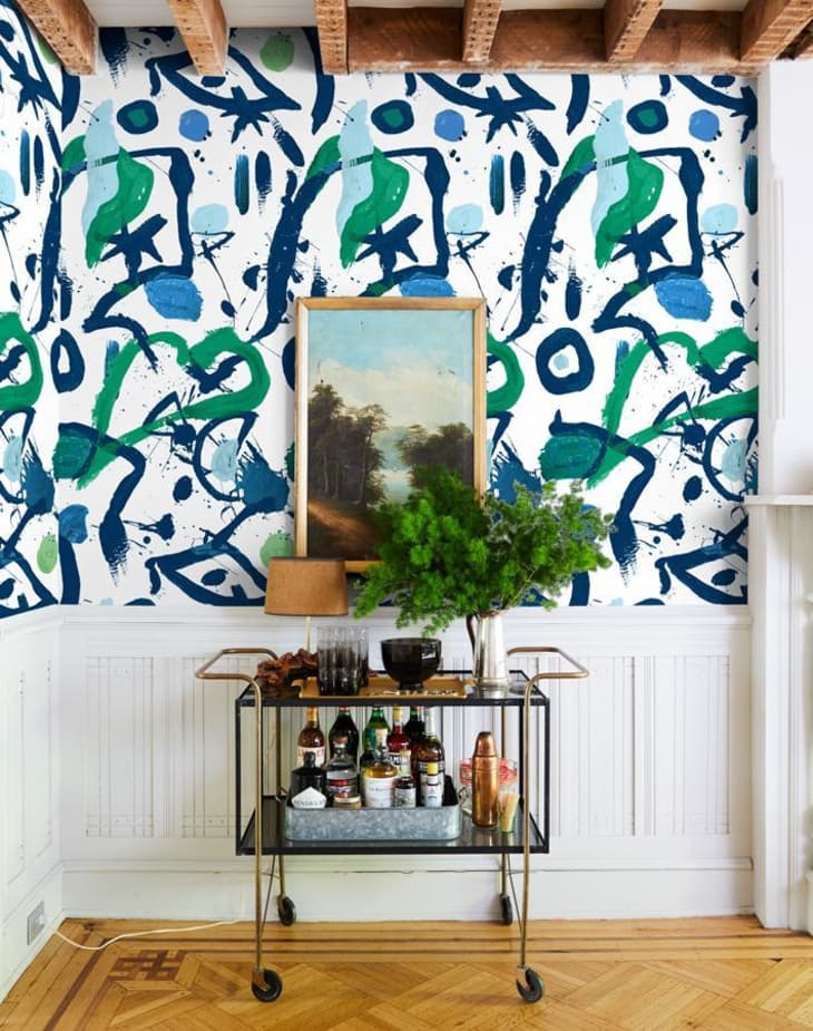 Squiggle and splatter wallpaper in a green and blue colorway in Chris Benz's dining room