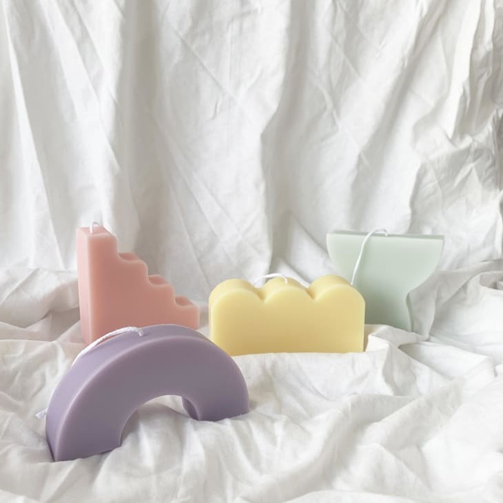 sculptural candles in pastel tones like pink, lavender, yellow, and mint