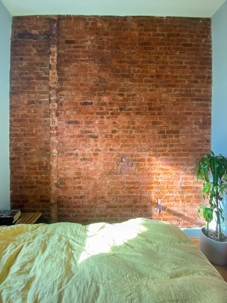 Daniela Araya's bare brick bedroom wall