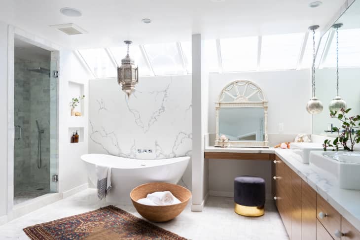 Freestanding tub in a white bathroom by Breegan Jane