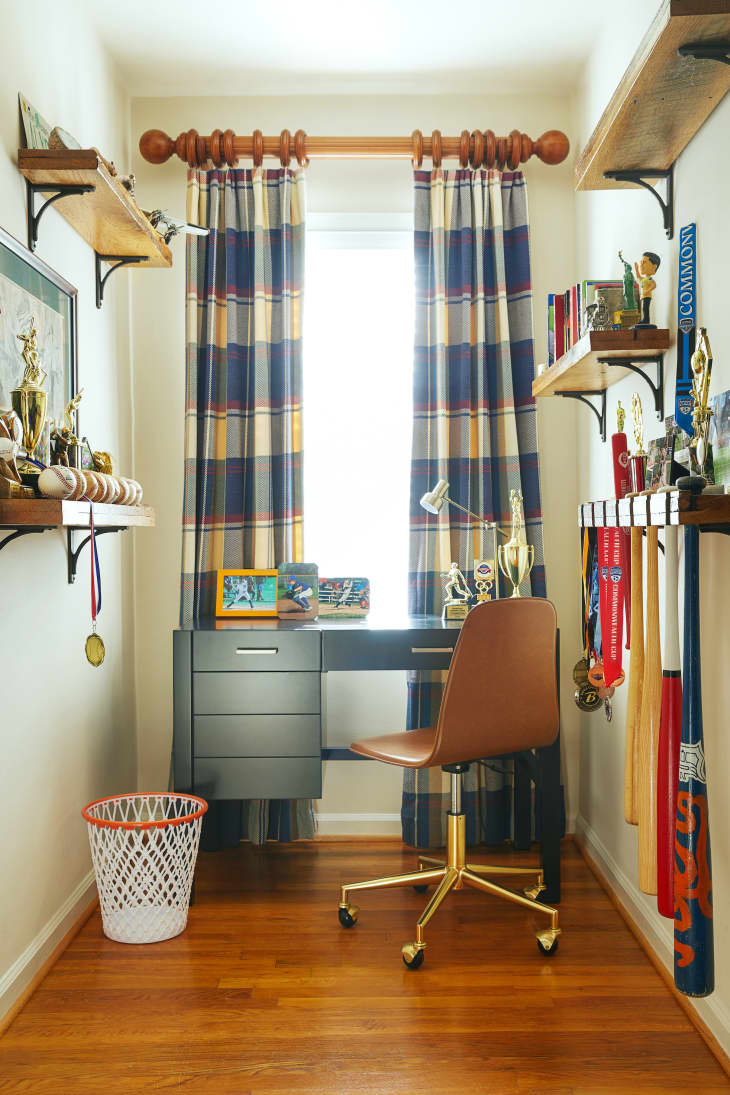 Small workspace with sports-themed decor in boy's room