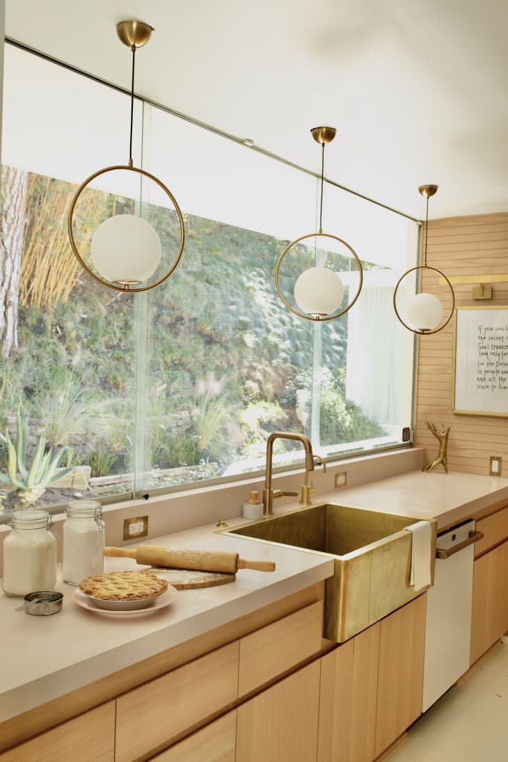 Warm wooden kitchen with a big window displaying the outdoors