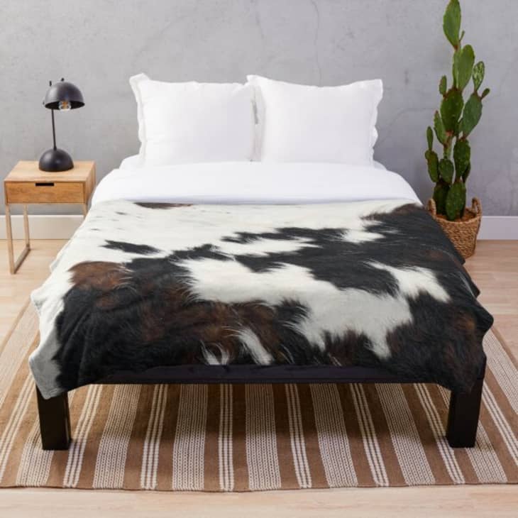 Cowhide blanket on bed
