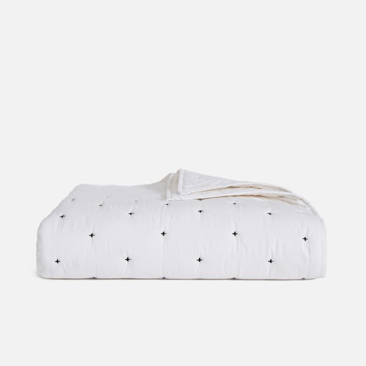 White quilt with black stitching from Brooklinen