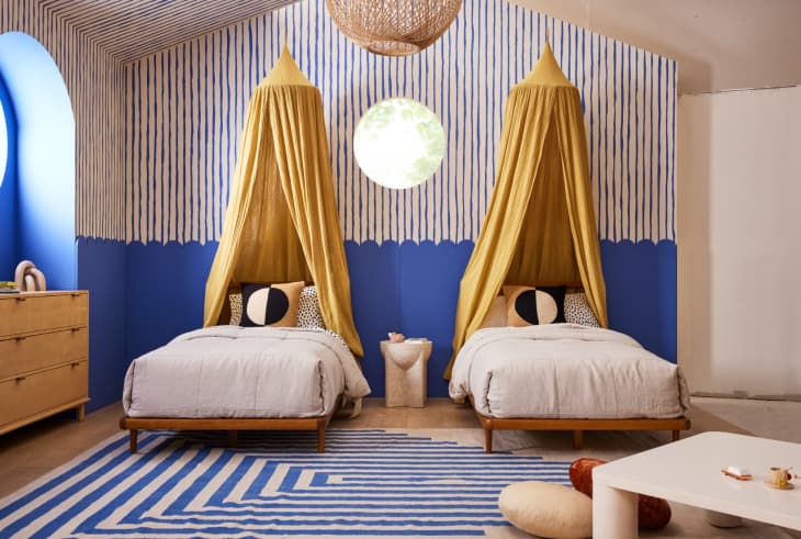 children's bedroom with two beds with canopies