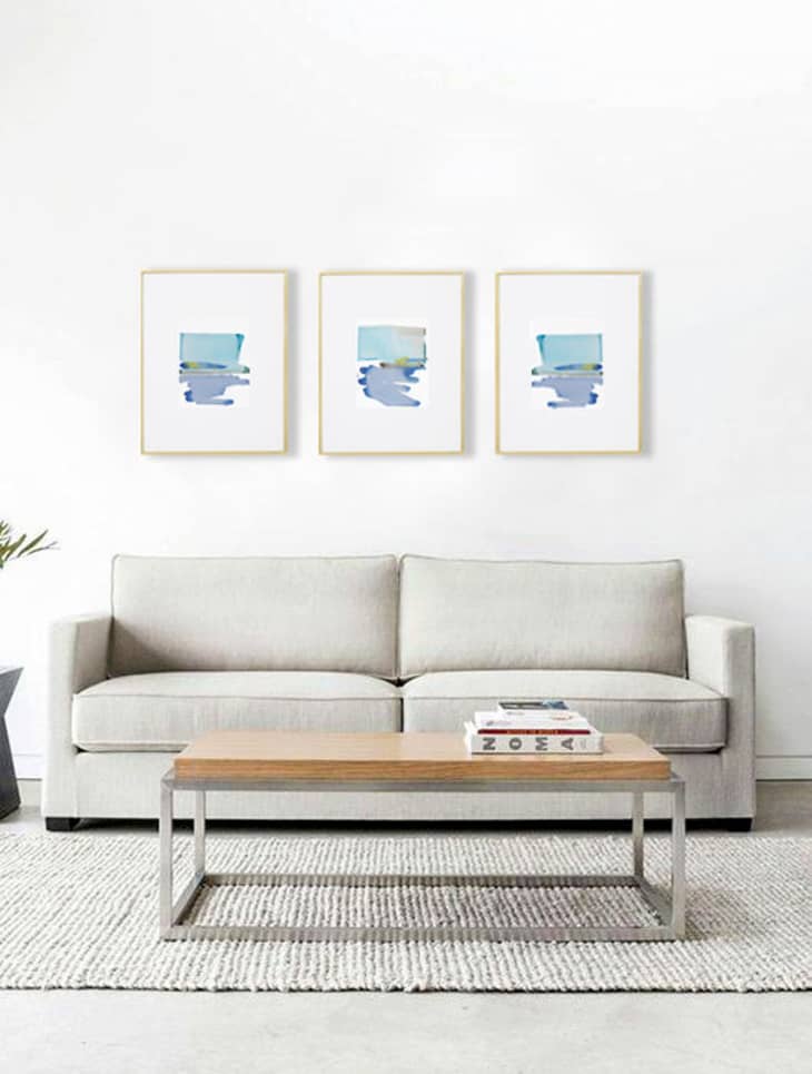 living room with three blue matching prints
