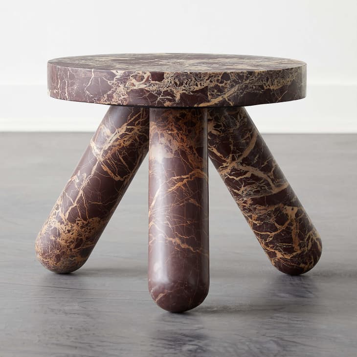Red marble side table with three legs from CB2