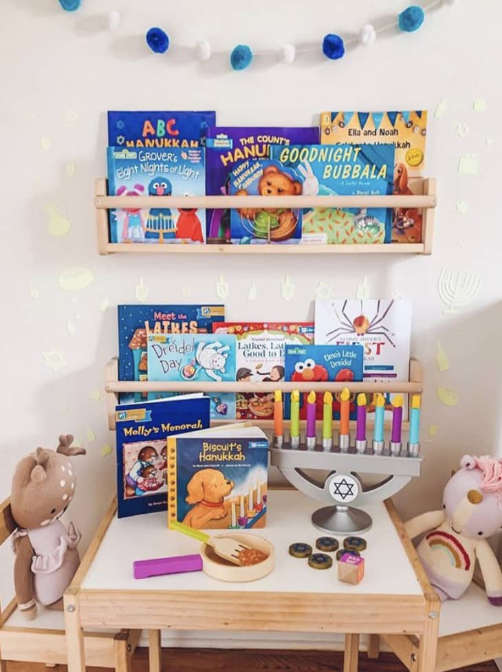 Ariel Scheer Stein's daughters' Hanukkah books in cute book rack shelves