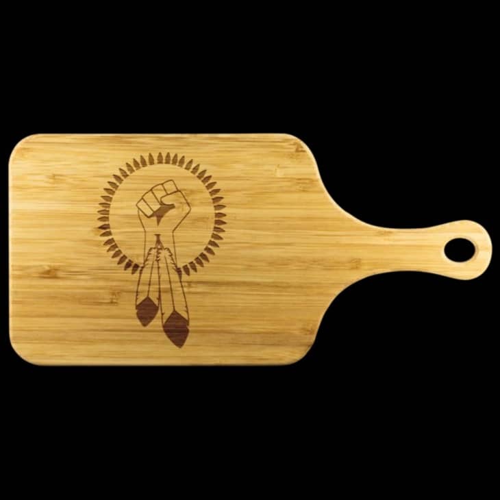 Cutting board with a feather and a fist motif