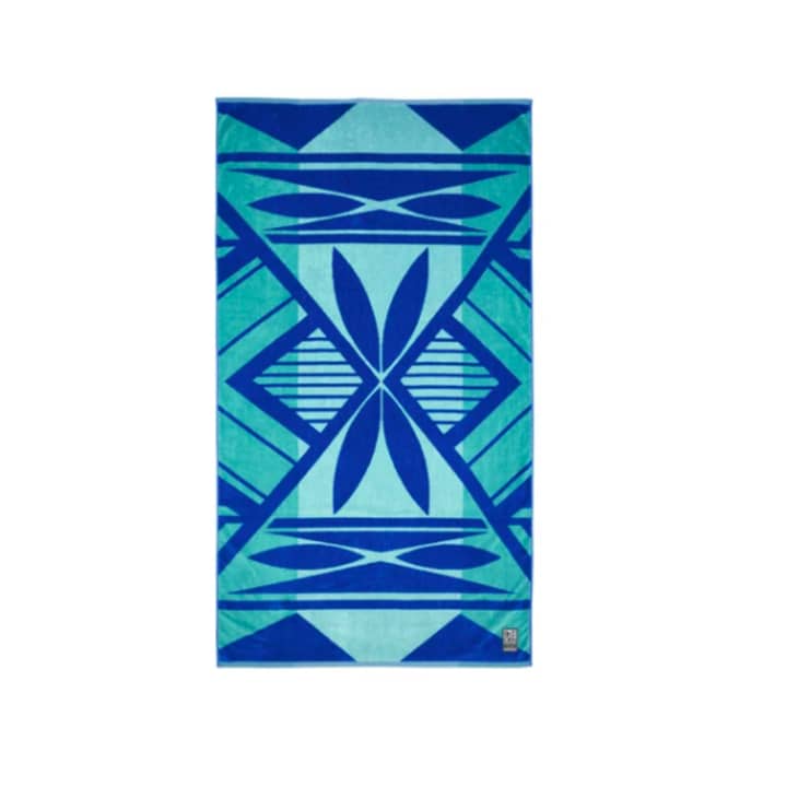 Blue and teal beach towel with a geometric motif