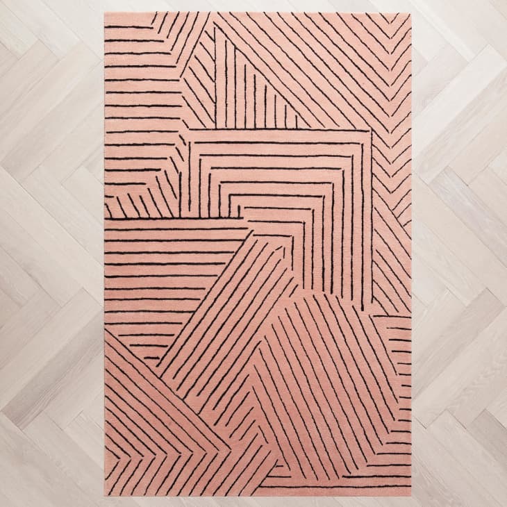 Mauve rug with a wood-block inspired graphic line pattern in black on it from Z Gallerie