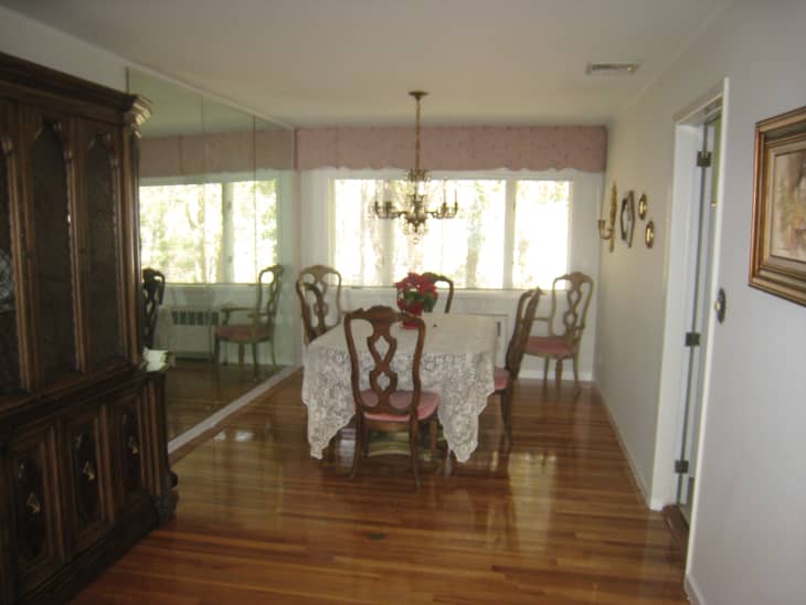 Dining room with mirrored wall and hardwood floors