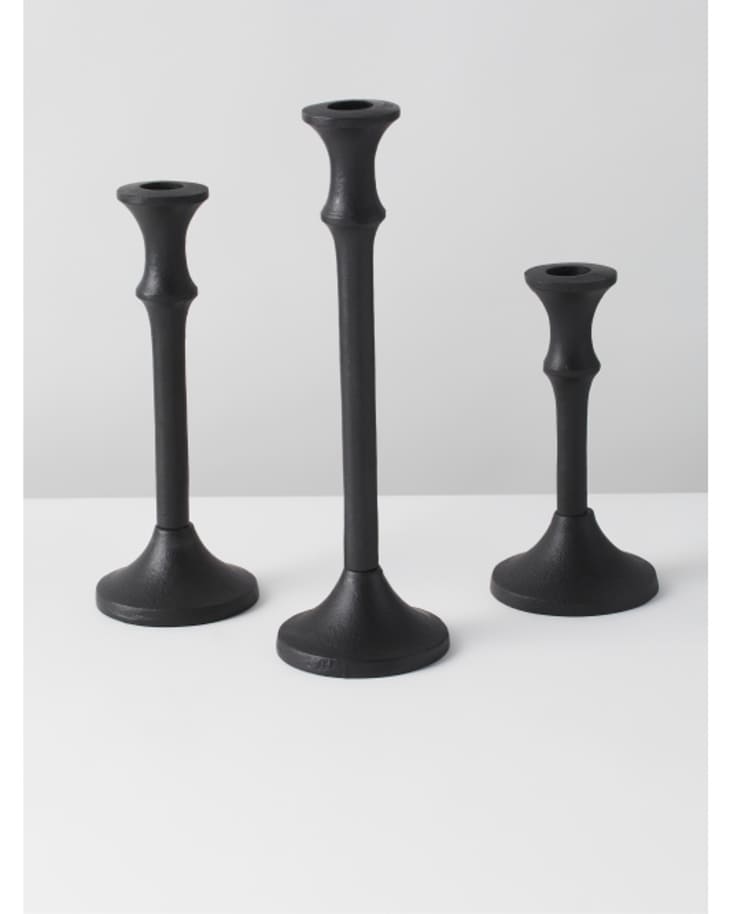 trio of black candlestick holders