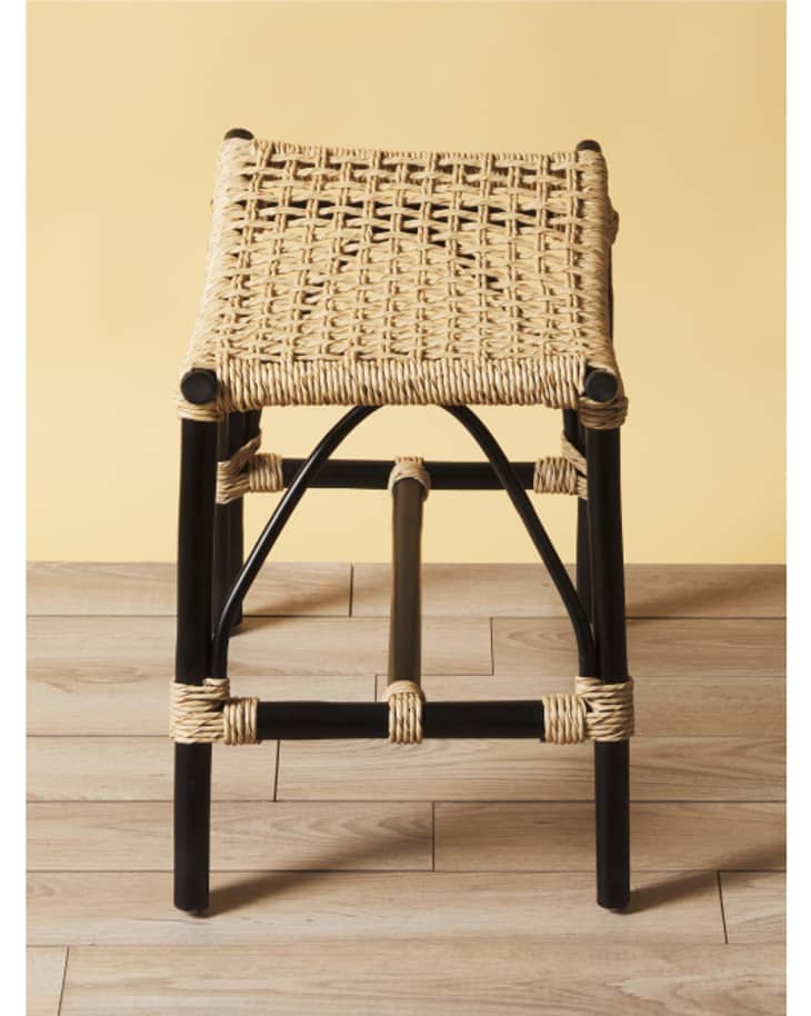 rattan woven stool with black legs