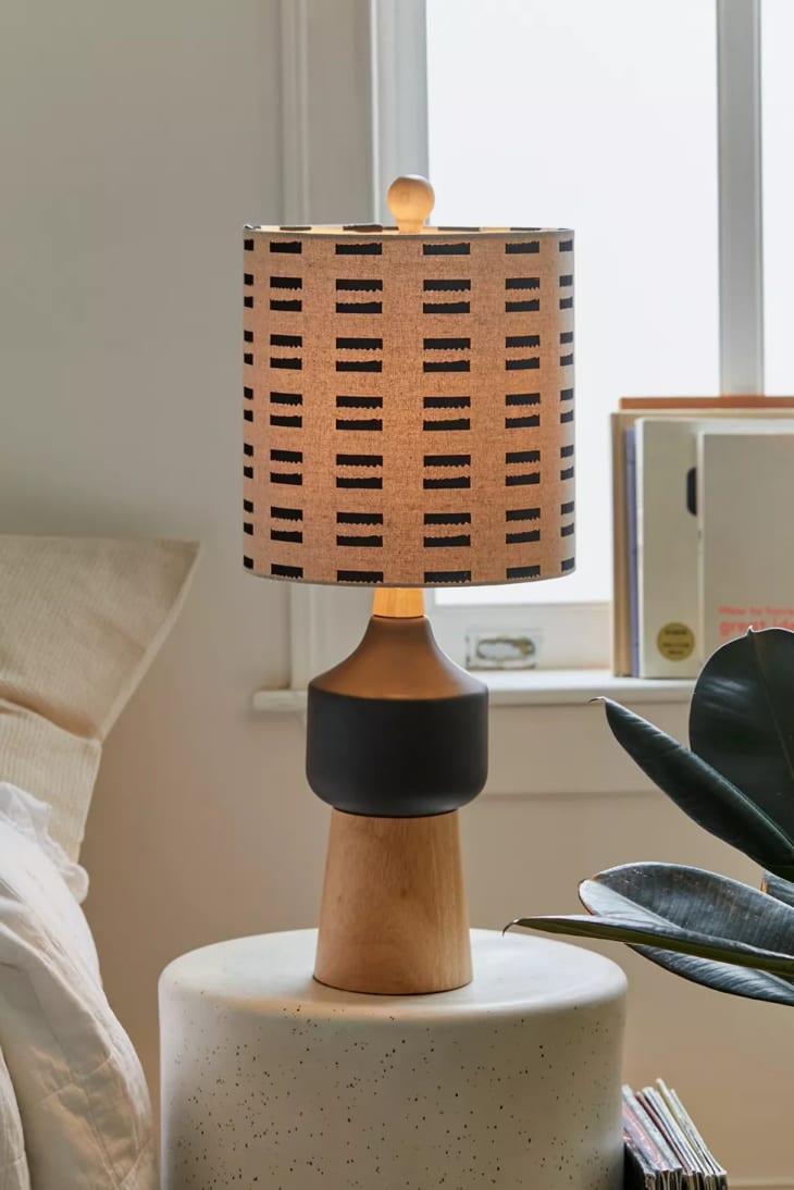 Lamp with a shade that has a hash mark motif