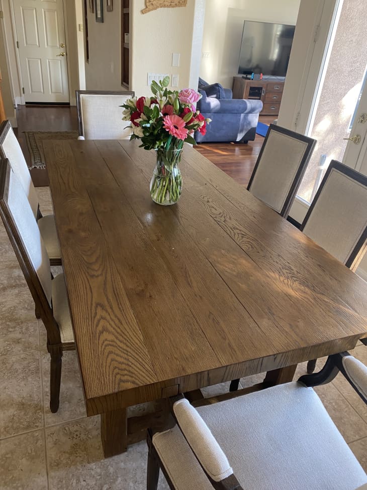 Farmhouse wood table with tan upholstered chairs
