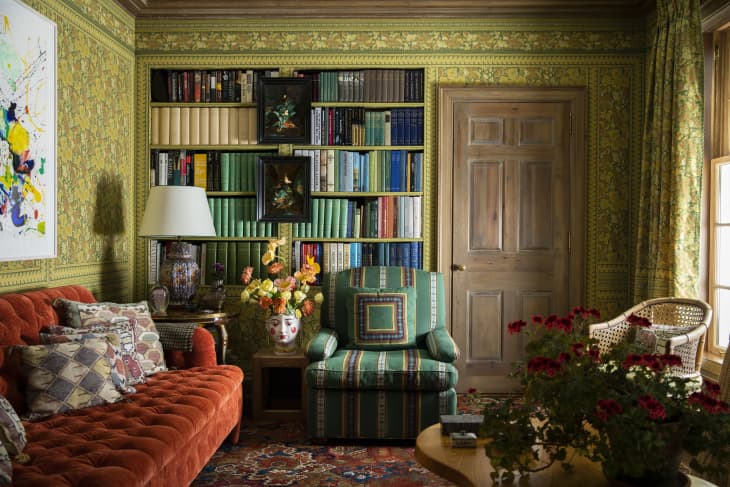 Green library room with an orange sofa