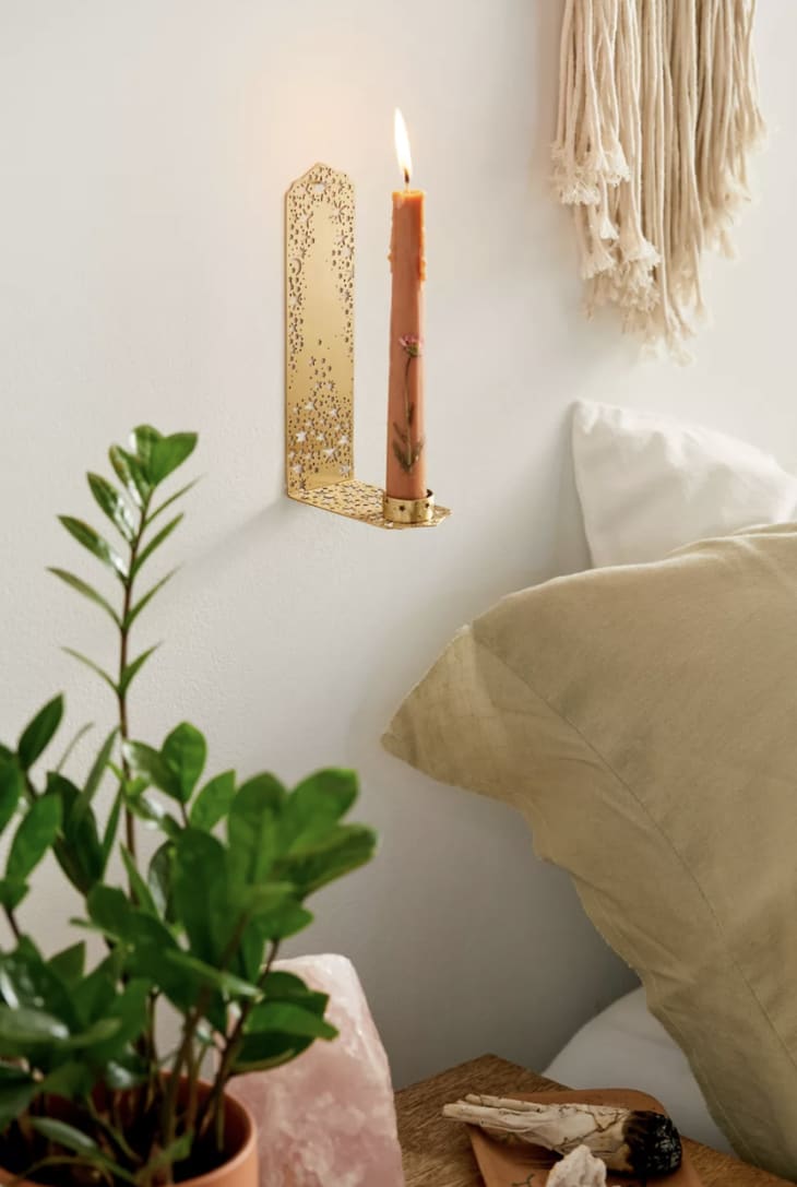Brass wall candle sconce with a star cut out motif