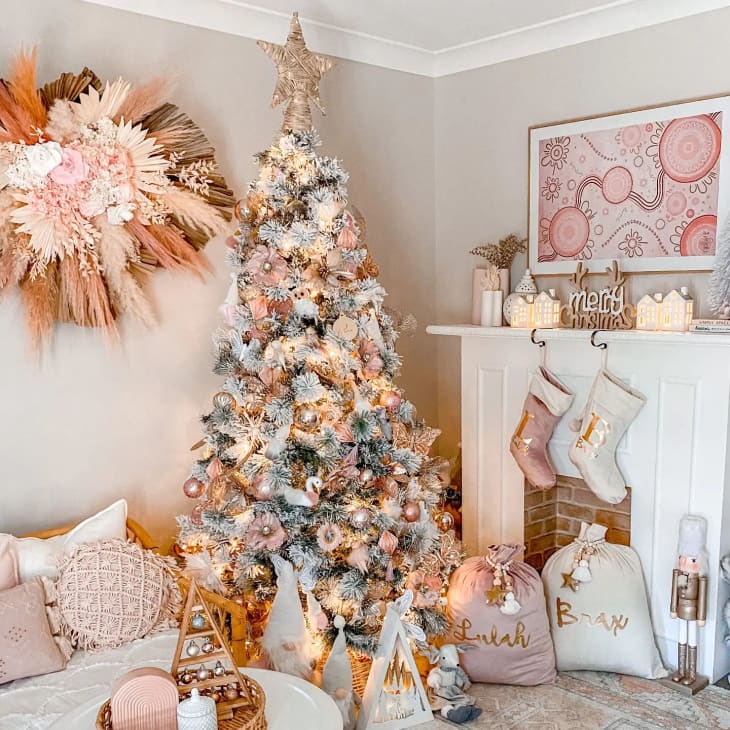 christmas tree with pink, gold, and white decorations in living room