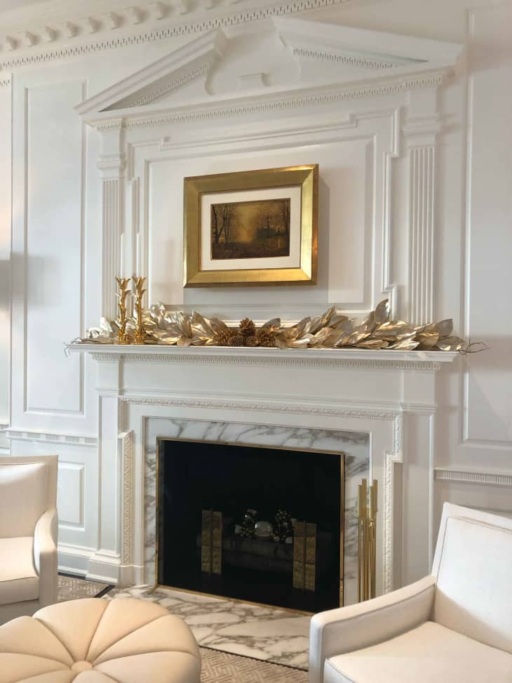 living room with fireplace and white, gold, and silver colors
